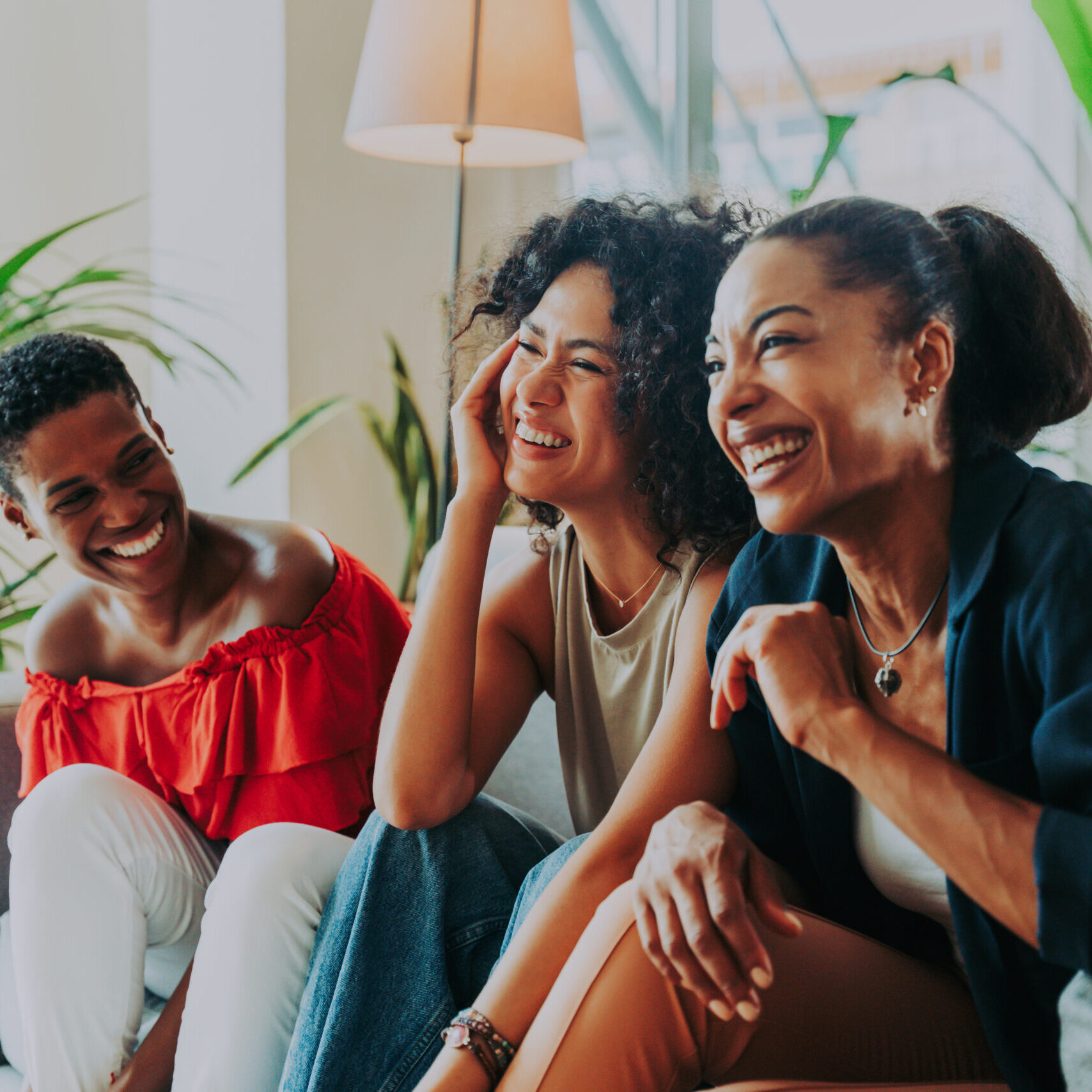 Happy beautiful hispanic south american and black women meeting indoors and having fun - Black adult females best friends spending time together, concepts about domestic life, leisure, friendship and togetherness